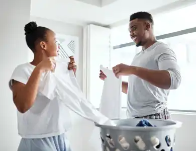 Couple Doing Laundry Shutterstock 2146083771